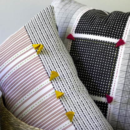 Kolkata Throw Pillow II in black and white with pink tassels, detail view